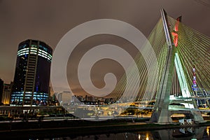 Buildings and cable stayed bridge at night