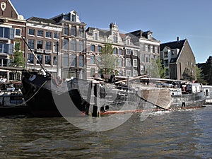 Buildings, canal and a boat in Amsterdam