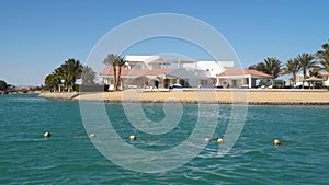 Buildings and canals in El Gouna. View from a floating ship.