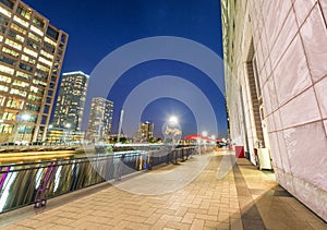 Buildings of Canary Wharf at night in London. View from the street