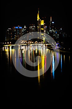Buildings and city reflections in Frankfurt city over the main river and ignatz bubis bridge, Germany photo