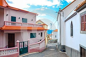 Buildings in coastal village Jardim do Mar, Madeira, Portugal. Waters of the Atlantic ocean in the background. Narrow street.