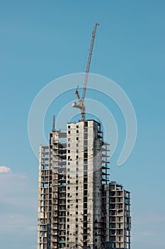 Buildings and crane construction site with blue sky