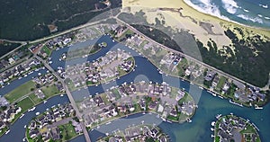 Buildings, earth and drone of city with lake, grass and infrastructure development for environment. Land, ocean and