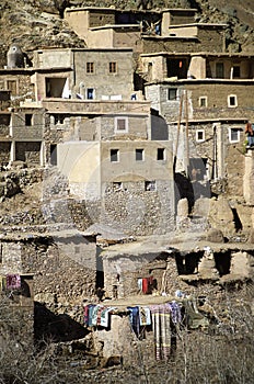 Buildings with hanging laundry on terraced slope