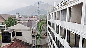 buildings, houses, and transmitting towers with mountain background