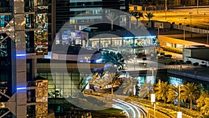 Buildings of Jumeirah Lakes Towers with traffic on the road night timelapse.