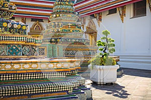 Buildings and many ornate chedis at the Wat Pho temple in Bangkok during a sunny day