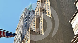 Buildings, modern and old architecture with usa flag and blue sky in manhattan in new york