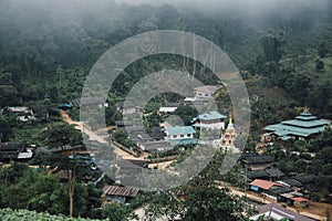 Buildings in mountain village. Foggy day, Top view village landscape