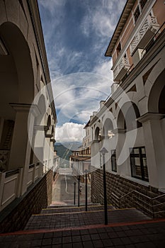 Buildings with mountains and clouds