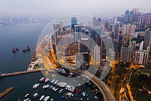 Buildings, ocean and aerial view of the city at night with lights, boats and ships on the sea harbor. Landscape