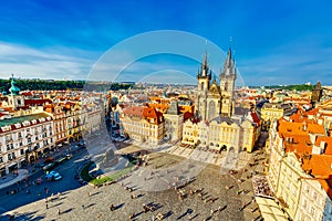 Buildings on the Old Town square Staromestska Namesti with Tyn Church in Prague, Czech Republic during summer sunny day with blue