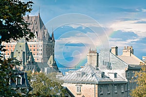 Buildings from Quebec in Canada, with a background of blue sky and rainbow. Concept of tourism and real estate