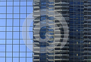 Buildings are reflected in the skyscrapers of the city of Calgary.