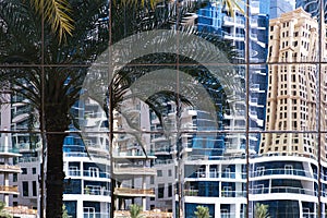 Buildings reflected in windows of modern office building.
