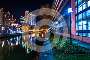 Buildings reflecting in the water at night in the Inner Harbor o