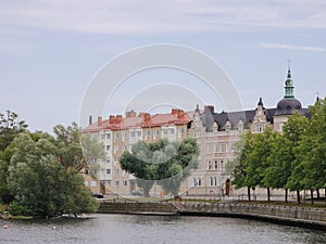 Buildings by river in city