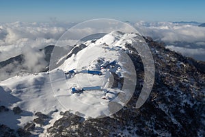 Buildings on Snow Covered Mountain Ridge