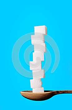 Buildings from sugar cubes and chocololate on a blue background