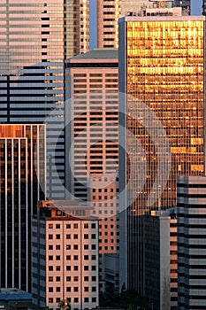 Buildings and sunset reflect