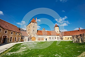 Buildings and towers of Blandy-les-Tours castle over blue sky