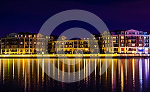 Buildings on the waterfront at night in the Inner Harbor, Baltimore, Maryland.