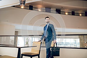 Buisnessman in a blue suit with a black suitcase