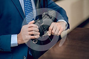 Buisnessman in a blue suit with a black suitcase