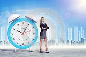 Buisnesswoman with crossed arms and big clock