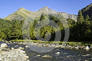 Bujaruelo Valley in the Pyrenees mountains in spring with the Ara river in foreground photo