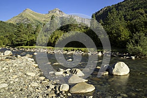Bujaruelo Valley in the Pyrenees mountains in spring with the Ara river in foreground