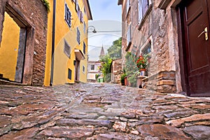 Buje. Old adriatic town of Buje stone street and church view