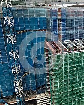 Aerial view of a construction site with crane in city center. Building of a new mall in Kuala Lumpur, Malaysia. Bukit Bintang City photo