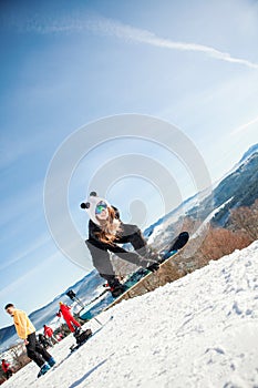 Bukovel, Ukraine - December 22, 2016: Man boarder jumping on his snowboard against the backdrop of mountains, hills and