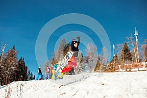 Bukovel, Ukraine - December 22, 2016: Man boarder jumping on his snowboard against the backdrop of mountains, hills and