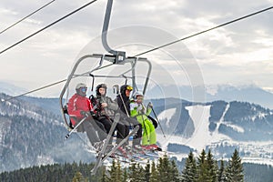 2016-12-17  Bukovel, Ukraine. Skiers on the chair lift in Bukovel Ski resort