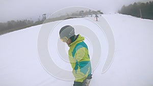 Bukovyrsia, Ukraine - December 19, 2020: man spinning on snowboard at the slope