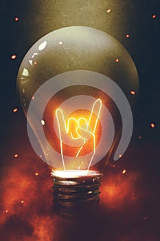 The bulb with glowing devil horns sign gesture hand photo