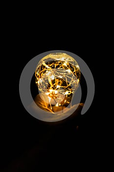 Bulb holding in hand with a nice blurry bokeh effect. photography art, light bokeh, reflection, night photography, background,