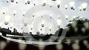 Bulb lamps floating at daylight over city