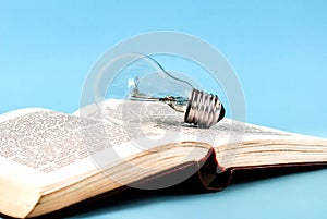 Bulb on an open old book close up