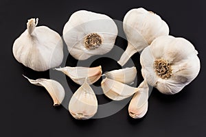 Bulbs and cloves garlic on a black background