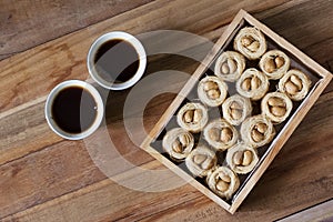 Bulbul Nest knafeh - a Middle Eastern sweet dish aysh el bolbol and Arabic coffee Qahwah with wooden background.