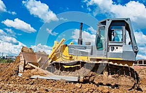 Buldozer moving earth. Road construction building work