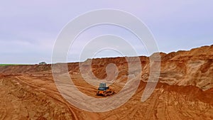 Buldozer working in sand quarry. Earth mover in sand quarry. Mining equipment