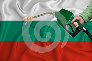 BULGARIA flag Close-up shot on waving background texture with Fuel pump nozzle in hand. The concept of design solutions. 3d