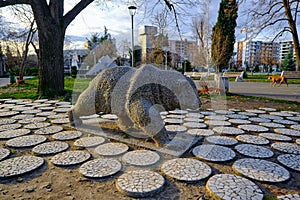 Bear sculpture in open park in Kardzali Bulgaria during early in the morning with sunshine.