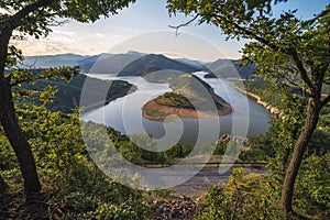 Bulgaria, Kardzhali dam, panoramic view of meander in Arda river, surrounded with green forest, summer time during sunset