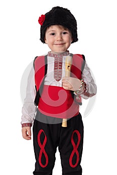 Bulgarian boy musician with flute in traditional folklore costume with martenitsa symbol of spring, Baba Marta and Easter holiday